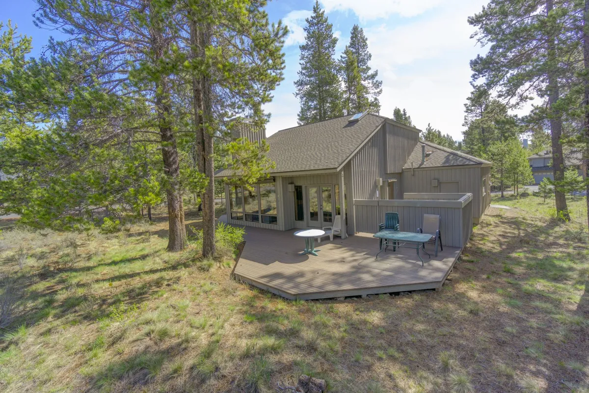 A welcoming deck with a comfortable seating area provides an inviting space to relax amidst lush greenery. The outdoor setup encourages family gatherings, nature walks, and shared moments in the fresh air.
