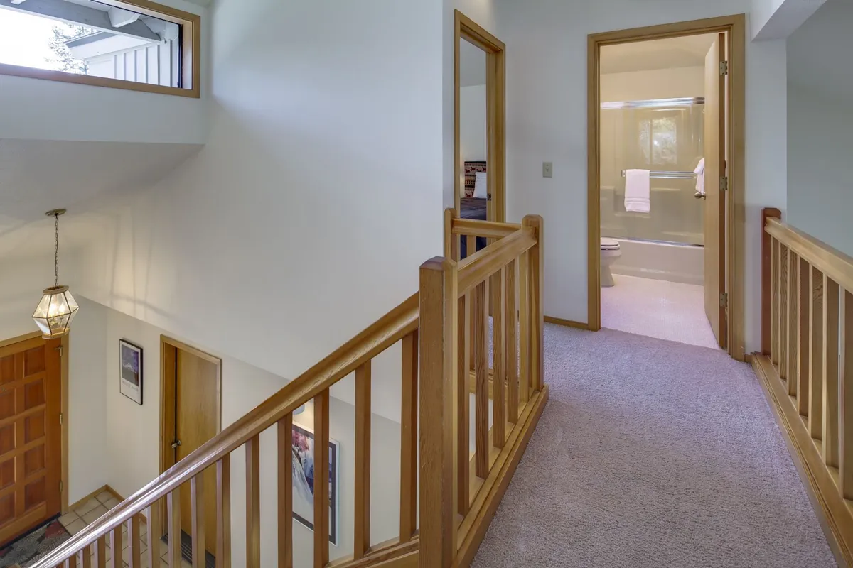 Shows the welcoming entryway with a staircase, front door, and cozy lighting—an inviting scene that sets the tone for arriving home after a day of exploration. It hints at the transition between outdoor activities and indoor relaxation.
